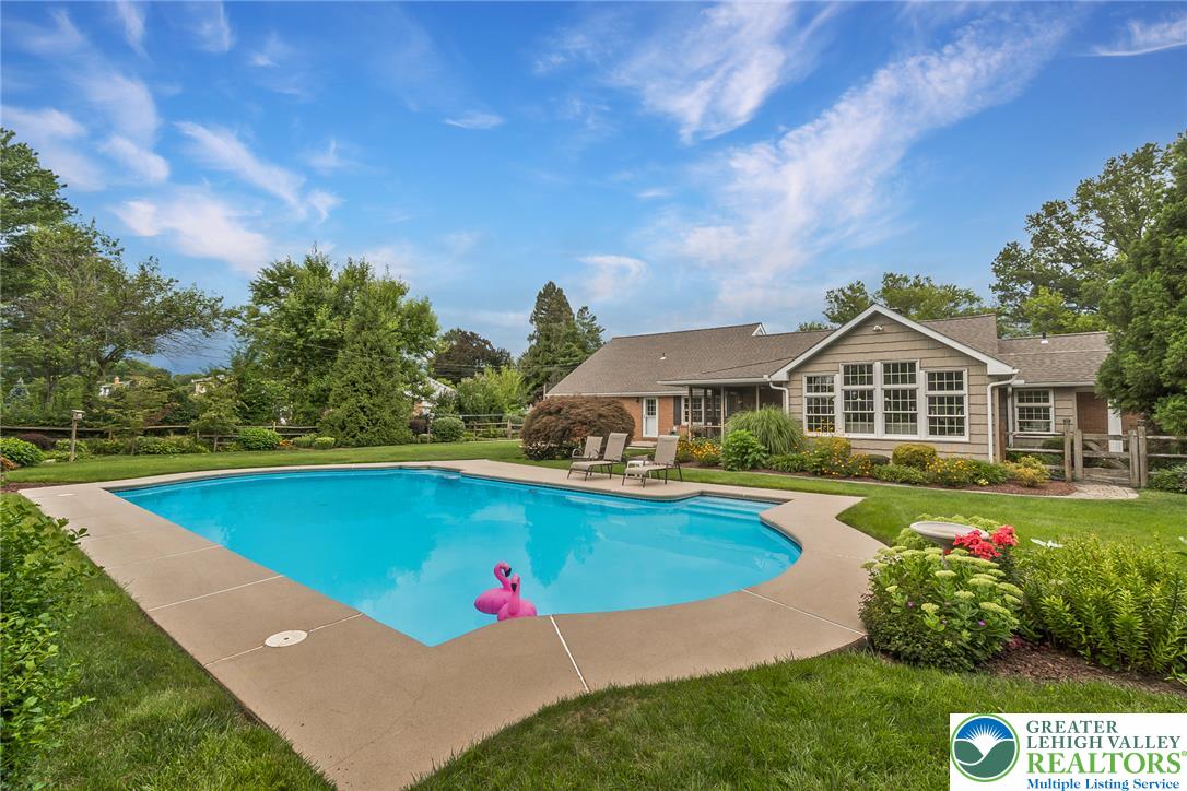 525 Wedgewood Road Bethlehem, PA 18017 - Photo 48 of 61 An inviting backyard oasis offers a pristine in-ground pool, expansive patio, and manicured landscaping.