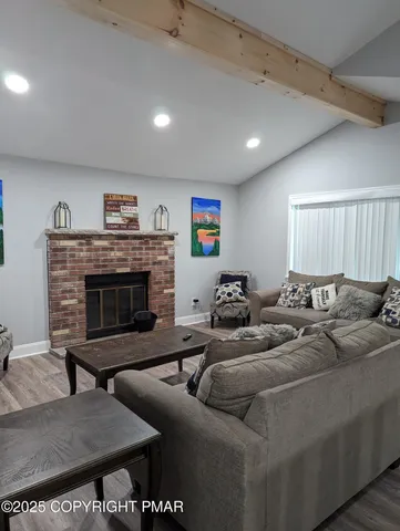 a living room with furniture and a fireplace