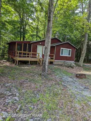 a view of backyard of house and trees