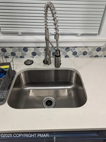 a close view of sink a faucet washer and dryer