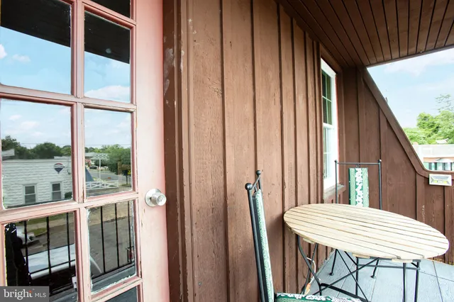 a view of a balcony with table and chairs