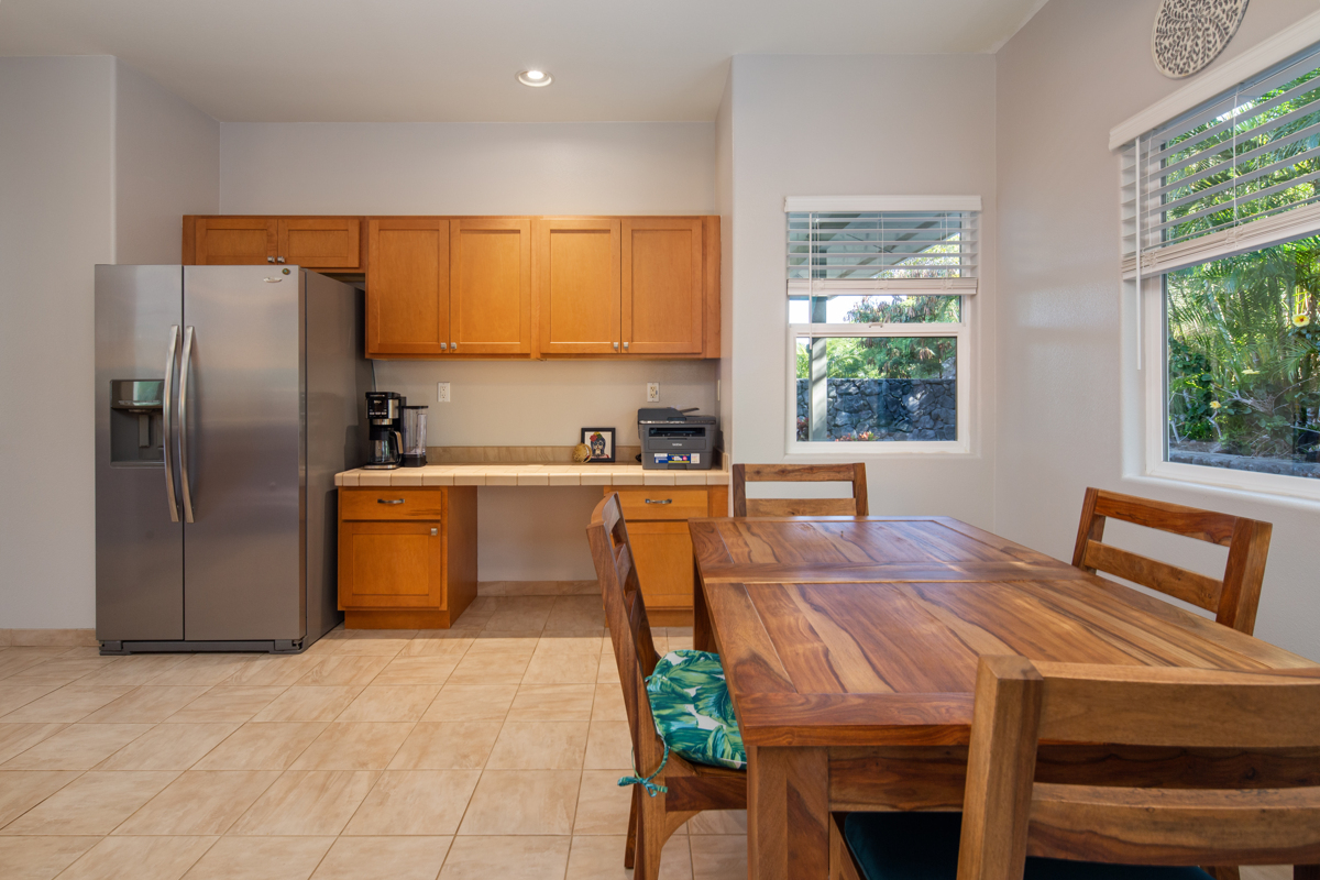68-1736 Ka'apuni Street Waikoloa, HI 96738 - Photo 11 of 30 a kitchen with stainless steel appliances wooden floor dining table and chairs