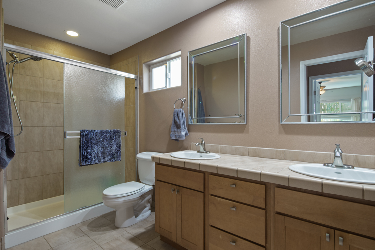 68-1736 Ka'apuni Street Waikoloa, HI 96738 - Photo 14 of 30 a bathroom with a toilet sink and mirror