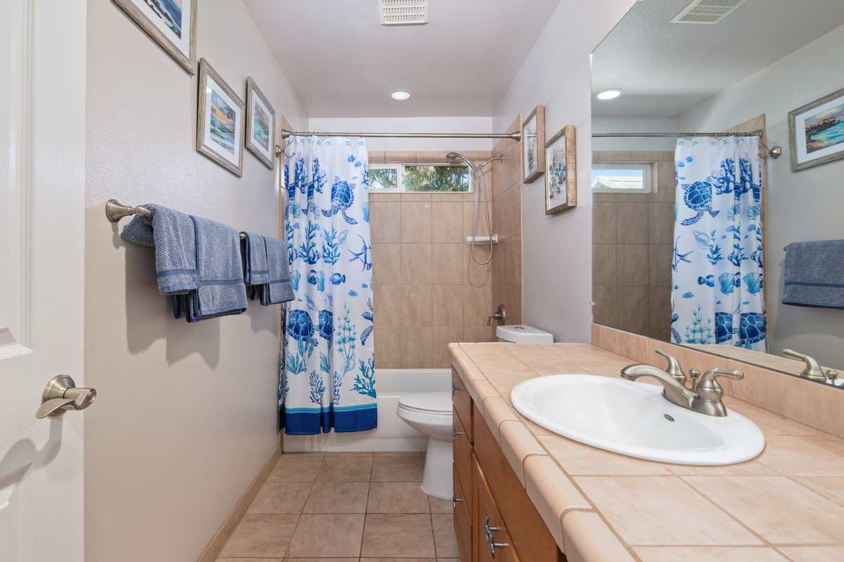 68-1736 Ka'apuni Street Waikoloa, HI 96738 - Photo 17 of 30 a bathroom with a sink a toilet and shower