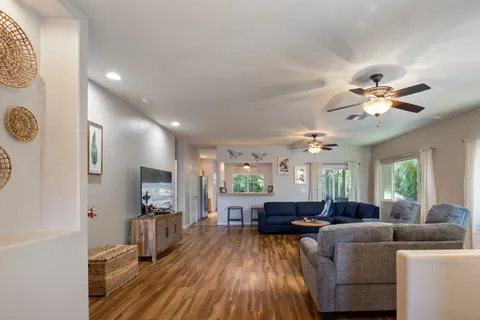 a living room with furniture and a wooden floor