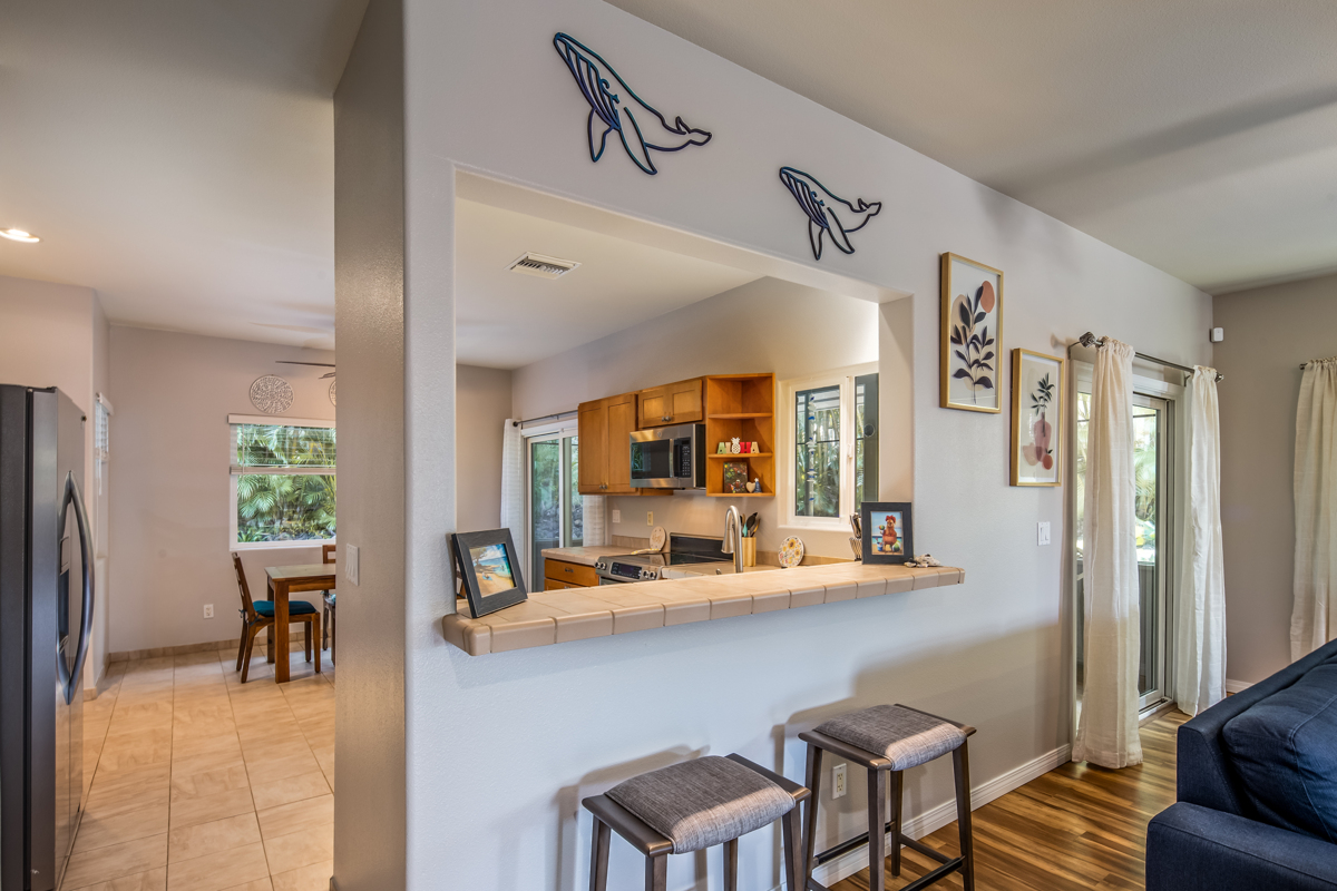 68-1736 Ka'apuni Street Waikoloa, HI 96738 - Photo 7 of 30 a room with stainless steel appliances kitchen island granite countertop furniture and a view of living room