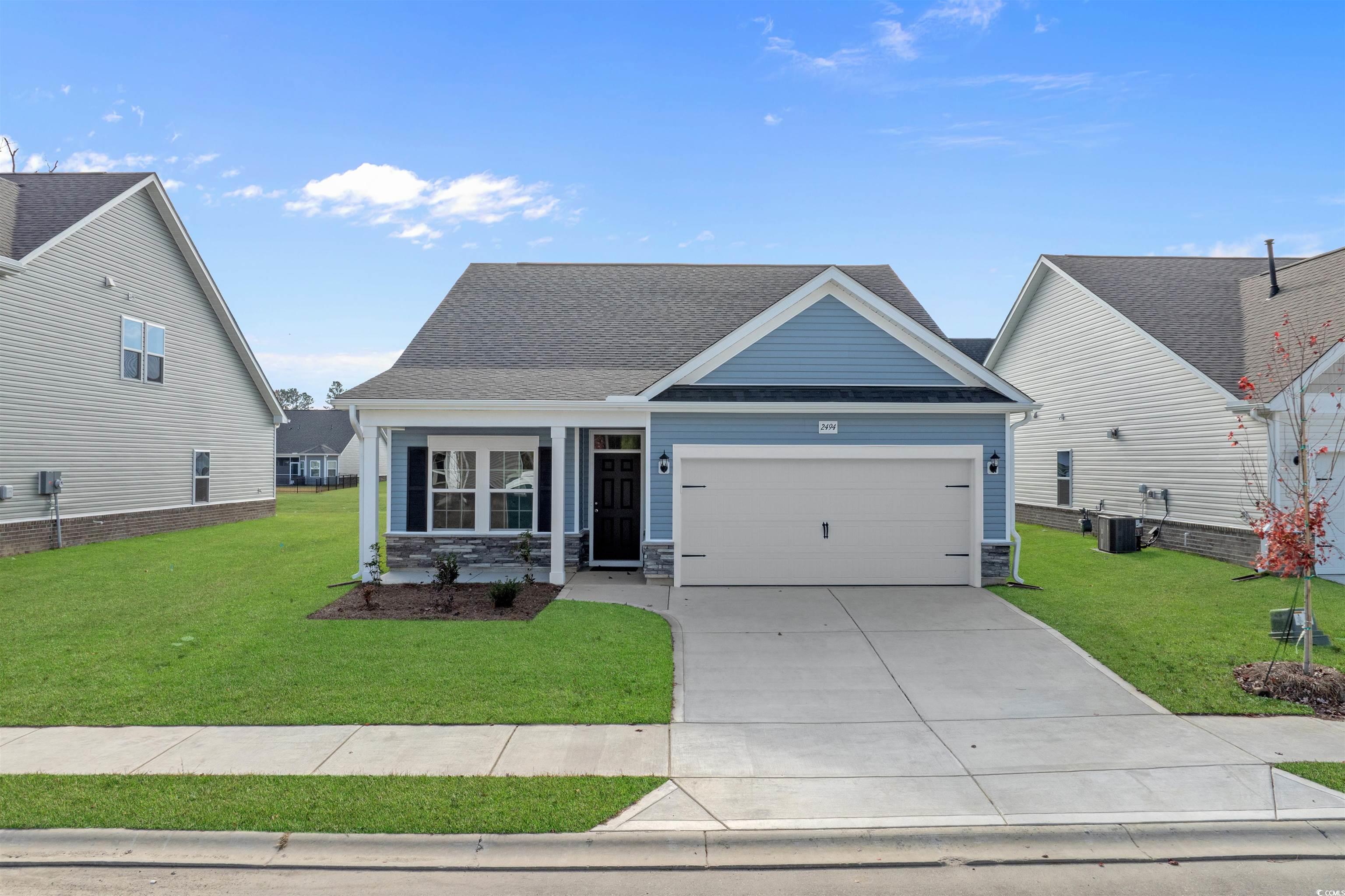 2494 Campton Loop Conway, SC 29527 - Photo 1 of 40 View of front of house with a front yard, stone siding, a garage, concrete driveway, and roof with shingles