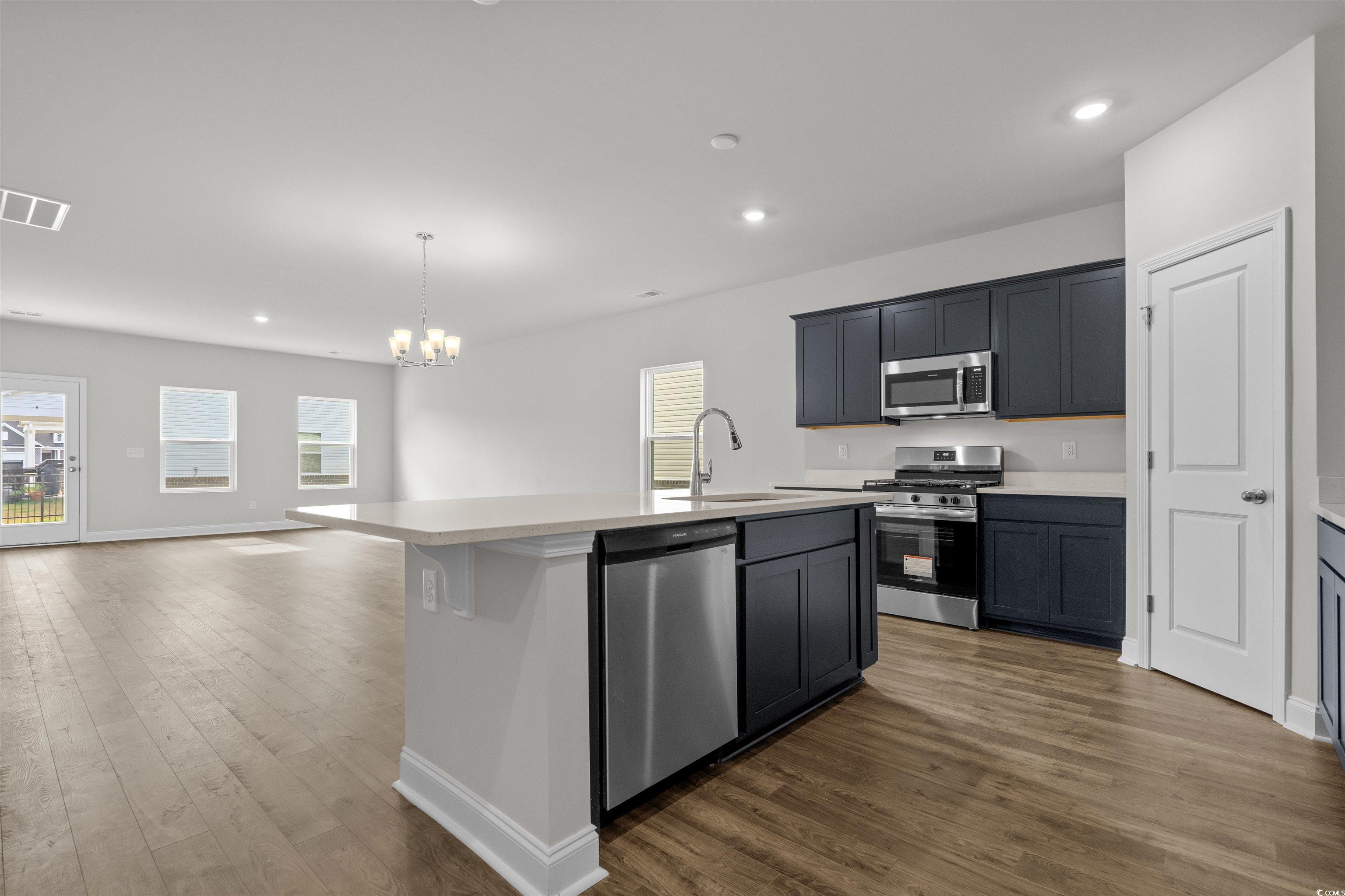 2494 Campton Loop Conway, SC 29527 - Photo 13 of 40 Kitchen featuring recessed lighting, a kitchen island with sink, pendant lighting, stainless steel appliances, and dark wood-type flooring