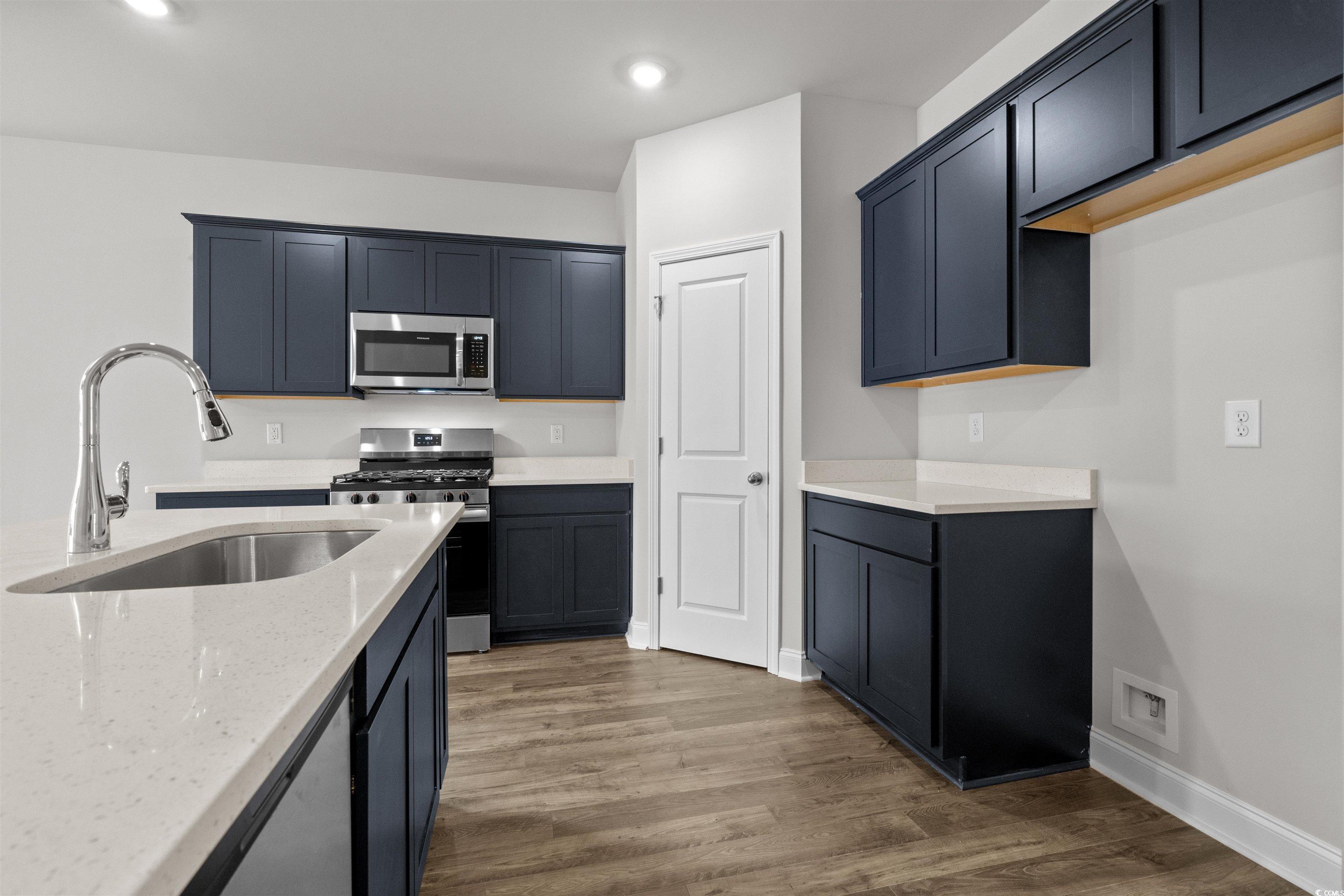2494 Campton Loop Conway, SC 29527 - Photo 14 of 40 Kitchen featuring light stone countertops, appliances with stainless steel finishes, dark wood-style flooring, and recessed lighting