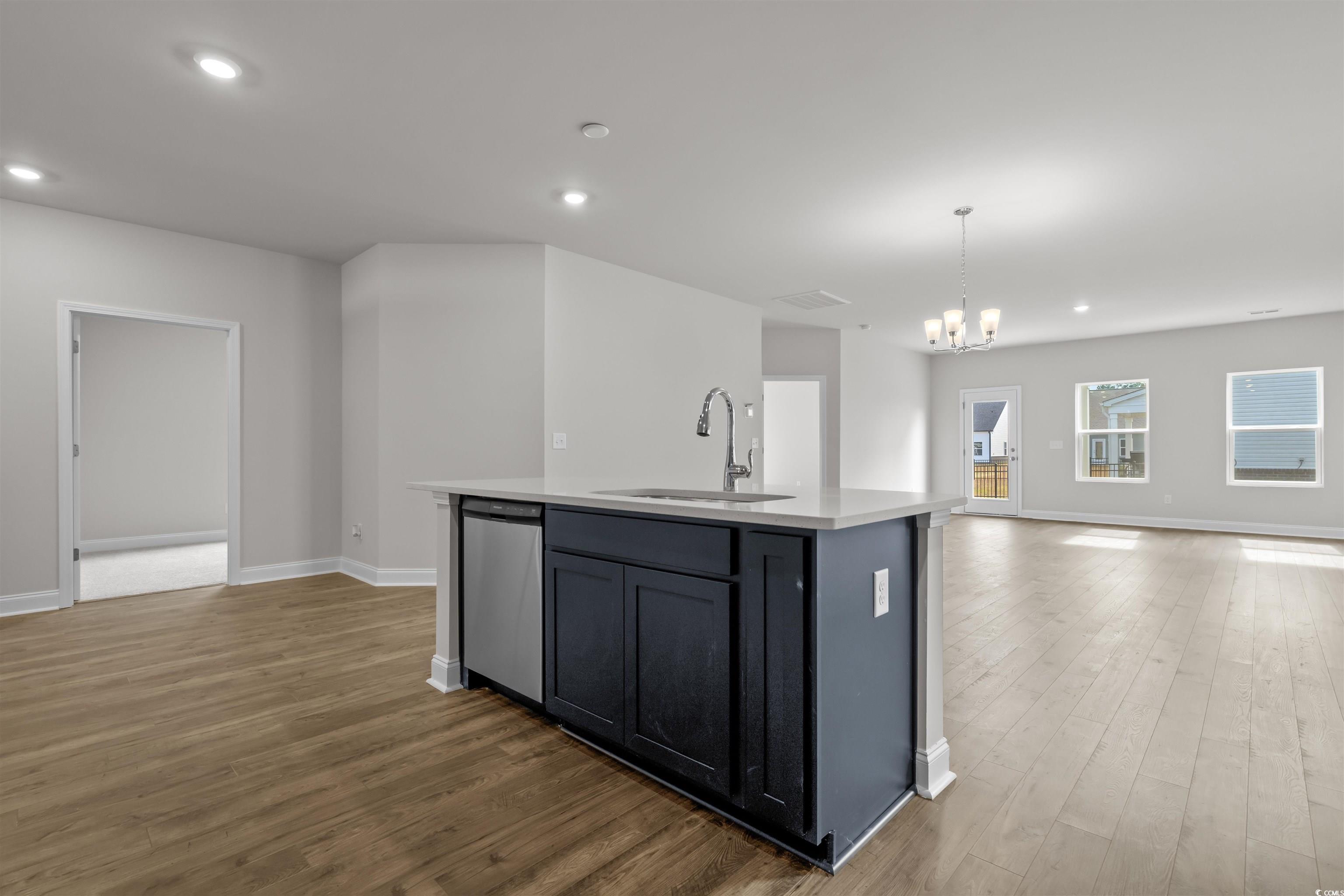 2494 Campton Loop Conway, SC 29527 - Photo 40 of 40 Kitchen featuring recessed lighting, open floor plan, a chandelier, hanging light fixtures, and an island with sink