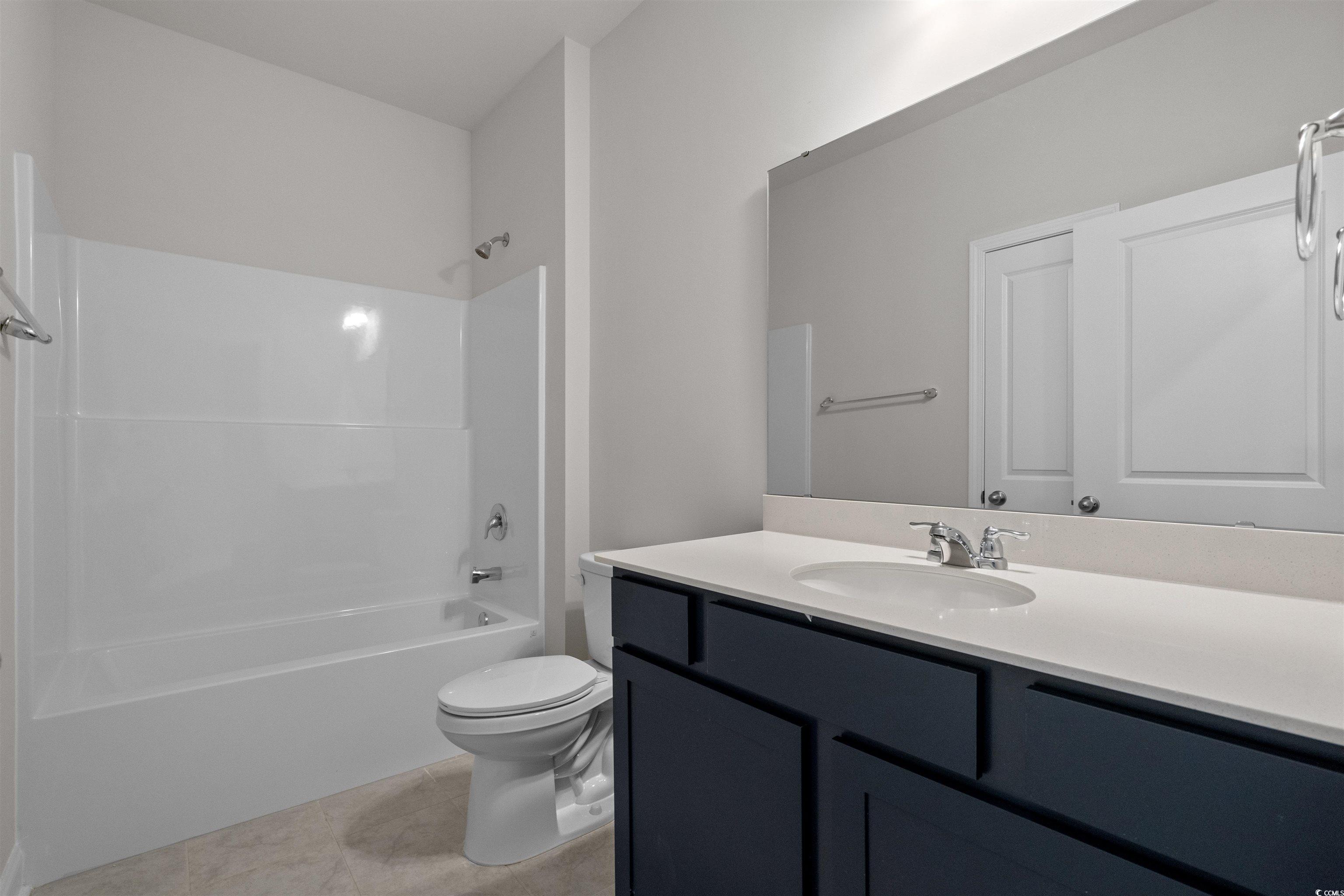2494 Campton Loop Conway, SC 29527 - Photo 27 of 40 Bathroom with tub / shower combination, vanity, and light tile patterned floors