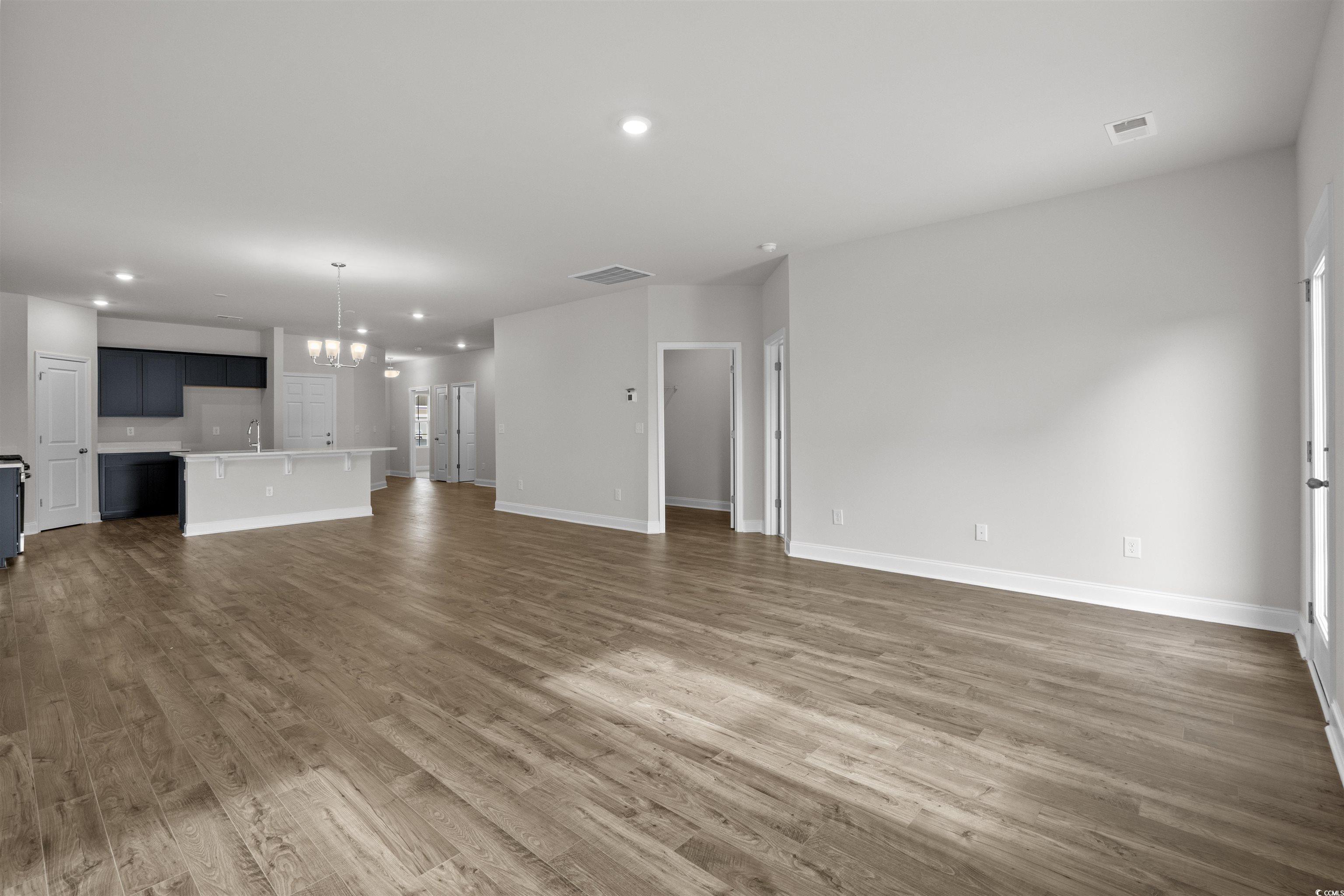 2494 Campton Loop Conway, SC 29527 - Photo 7 of 40 Unfurnished living room featuring a chandelier, recessed lighting, and dark wood-style flooring