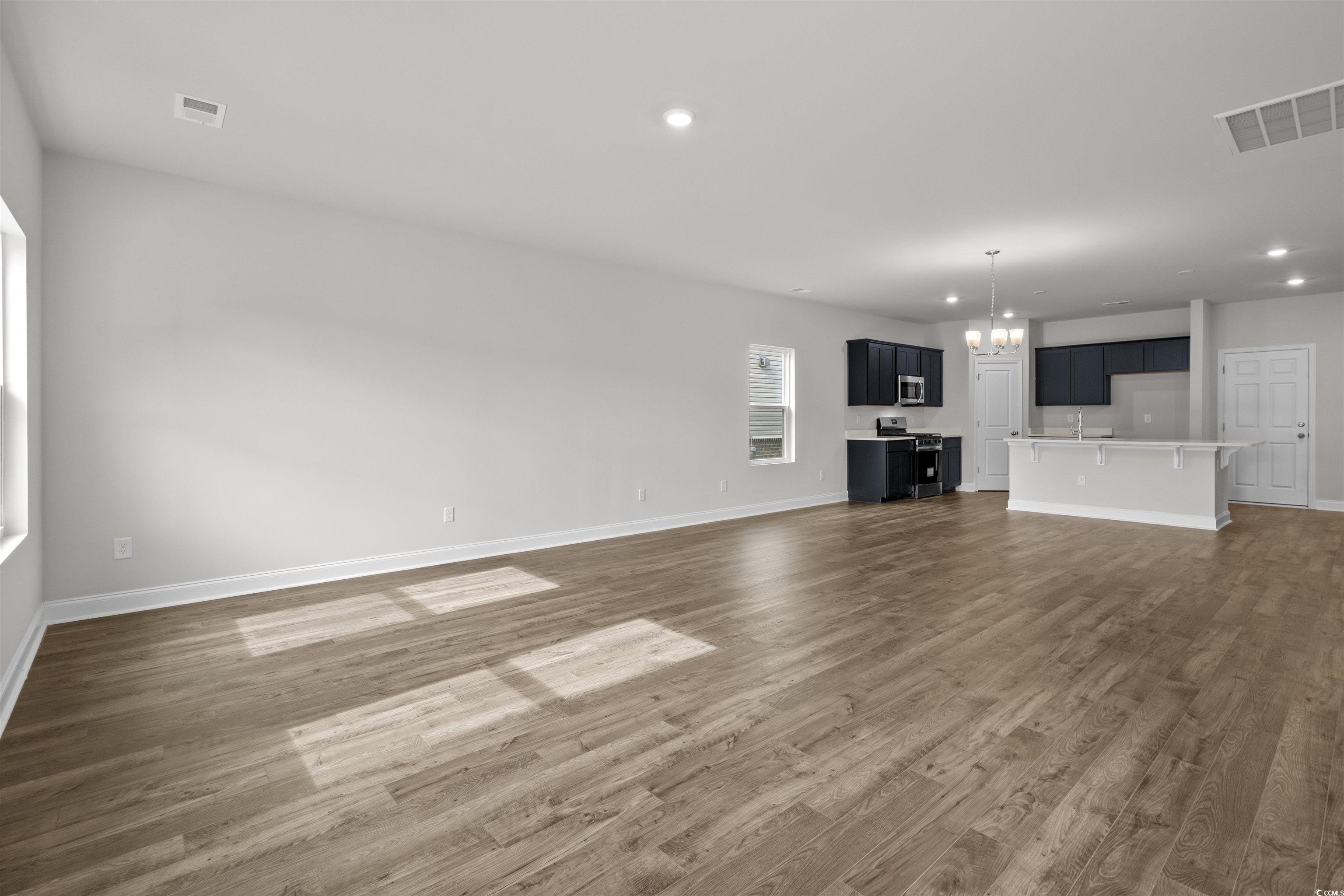 2494 Campton Loop Conway, SC 29527 - Photo 8 of 40 Unfurnished living room featuring recessed lighting, a chandelier, and dark wood-style flooring