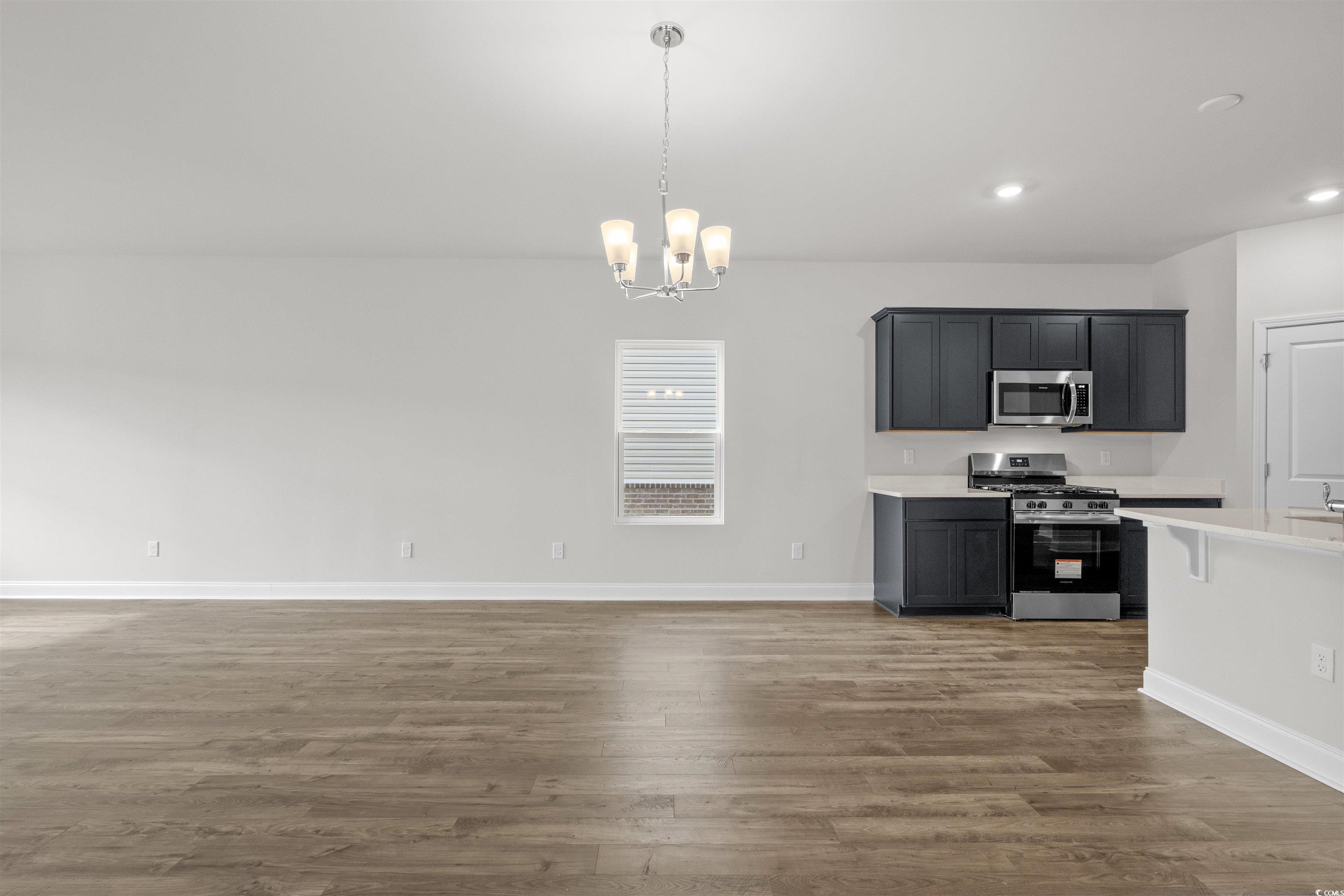 2494 Campton Loop Conway, SC 29527 - Photo 9 of 40 Kitchen with appliances with stainless steel finishes, hanging light fixtures, a chandelier, dark wood-style floors, and recessed lighting