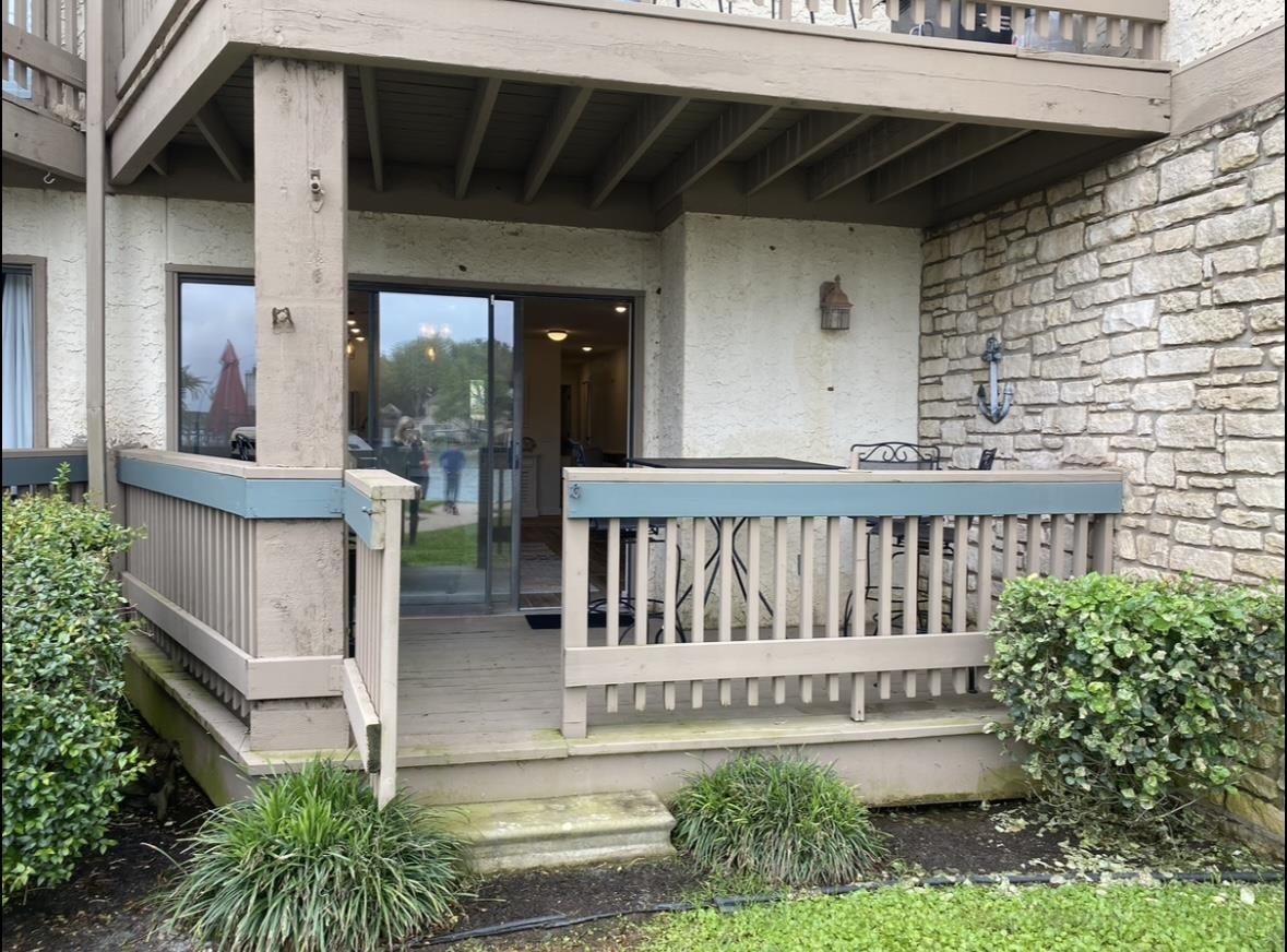 509 Short Circuit, Unit 108 Horseshoe Bay, TX 78657 - Photo 16 of 22 a view of a house with a small yard and wooden floor and fence