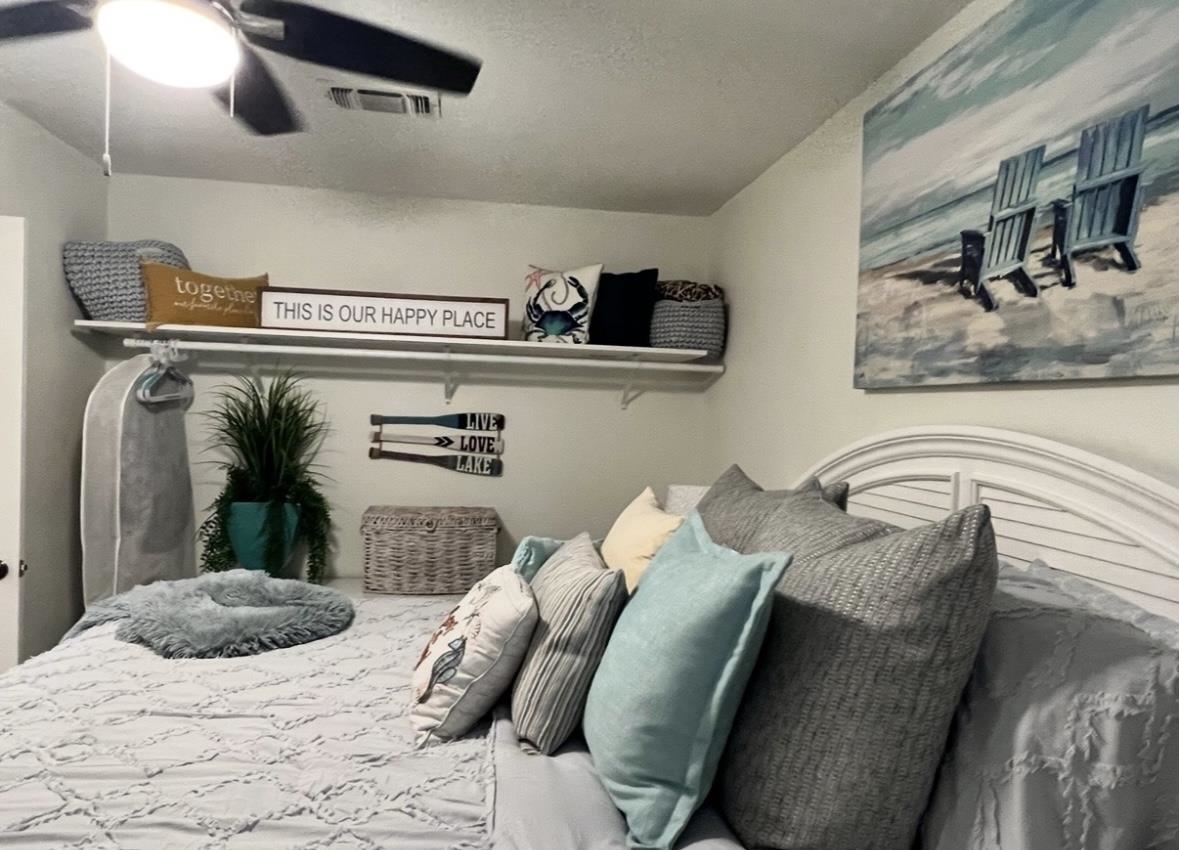 509 Short Circuit, Unit 108 Horseshoe Bay, TX 78657 - Photo 19 of 22 a bedroom with a bed and dresser