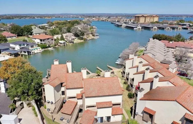 an aerial view of a house with a lake view