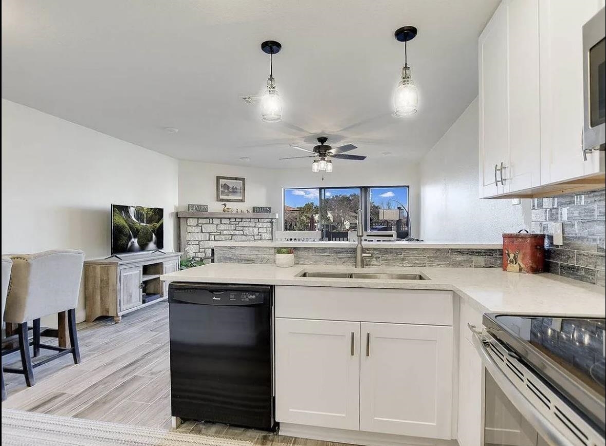 509 Short Circuit, Unit 108 Horseshoe Bay, TX 78657 - Photo 6 of 22 a kitchen with a sink stove and cabinets