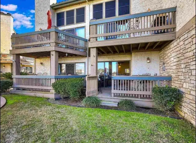 a view of a house with a yard and deck