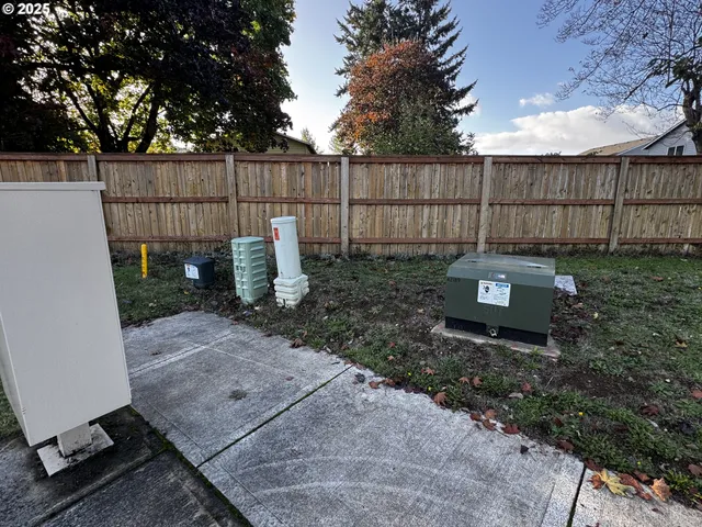 a view of a backyard with wooden fence