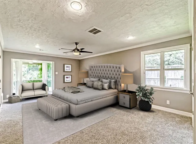 a living room with furniture ceiling fan and a large window