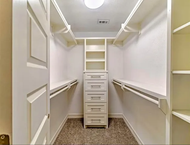 a view of walk in closet with stairs