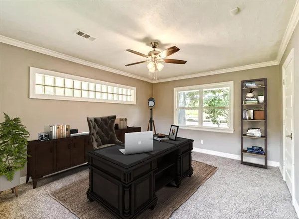 a living room with furniture a desk and a window