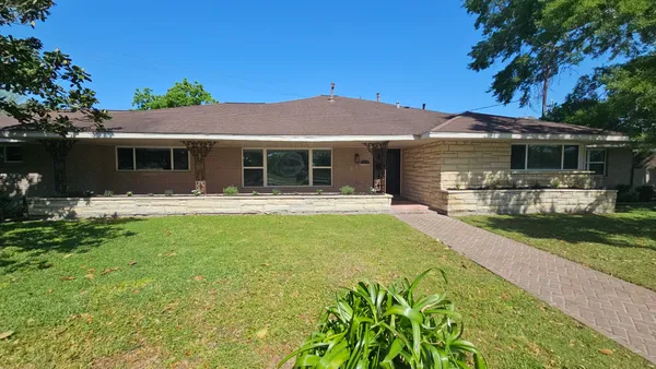 a front view of house with yard and green space