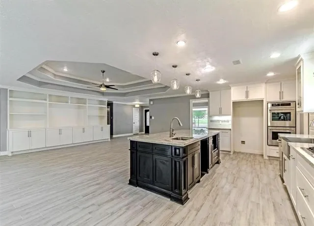 a kitchen with stainless steel appliances granite countertop a sink and cabinets
