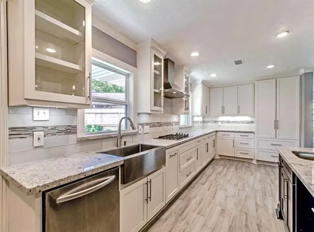 a open kitchen with stainless steel appliances granite countertop a stove a sink and a refrigerator