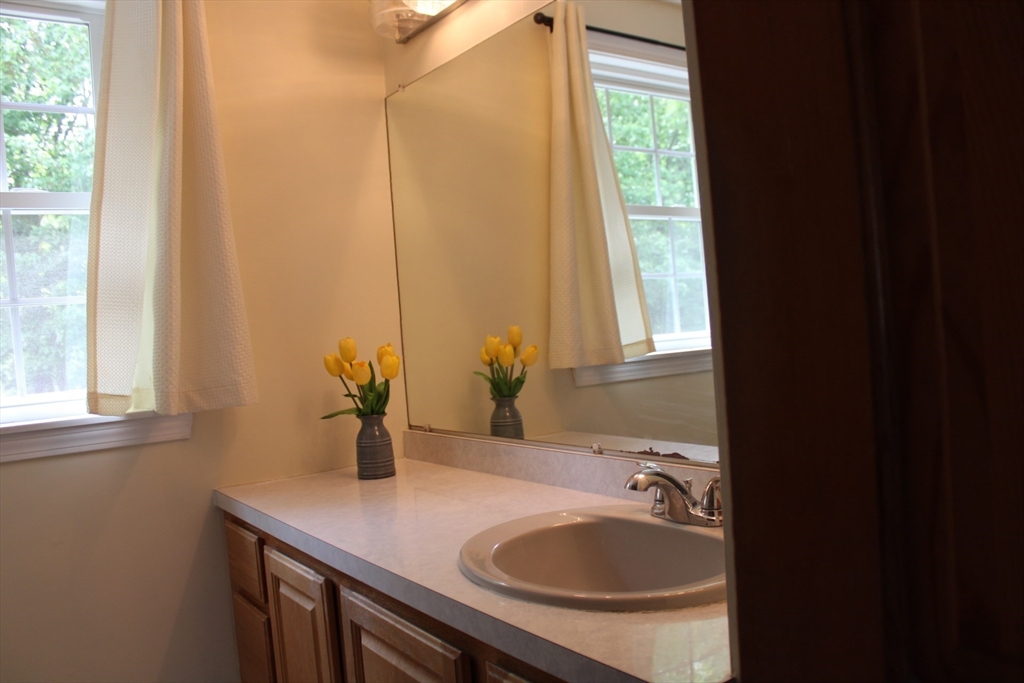 27 Gretchen Way Raynham, MA 02767 - Photo 13 of 20 a bathroom with a sink and a mirror