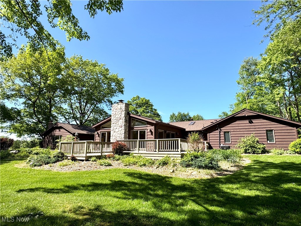 4010 State Road Medina, OH 44256 - Photo 29 of 50 Rear view of property featuring a wooden deck, a yard, and a chimney