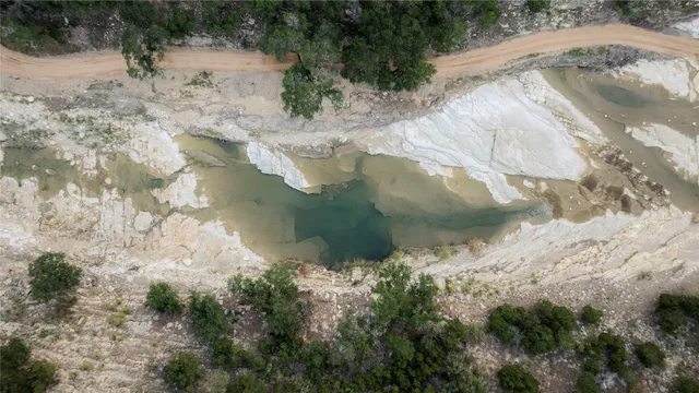 a view of a dry yard with a lake view
