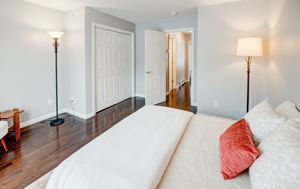 900 Lawrence Street, Unit 5 Lowell, MA 01852 - Photo 14 of 41 a bedroom with a bed and a lamp