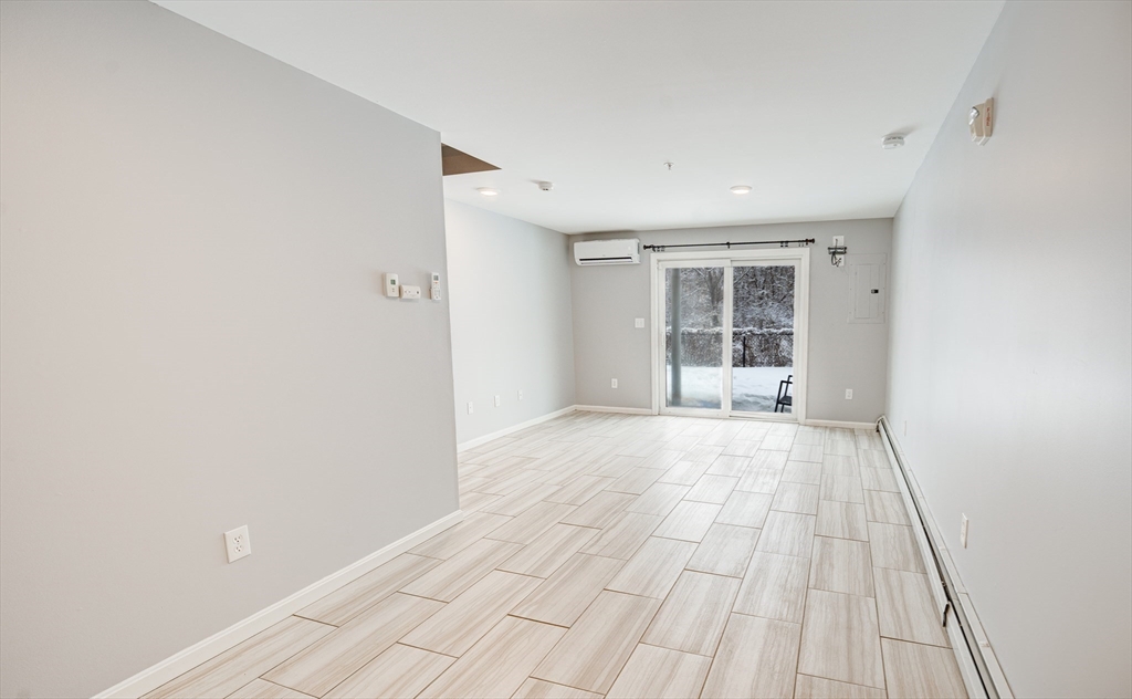 900 Lawrence Street, Unit 5 Lowell, MA 01852 - Photo 24 of 41 a view of an empty room with wooden floor and a window