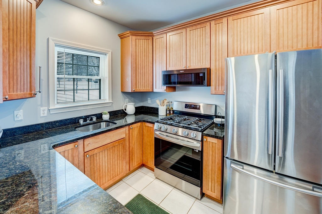 900 Lawrence Street, Unit 5 Lowell, MA 01852 - Photo 3 of 41 a kitchen with stainless steel appliances granite countertop a refrigerator stove and sink