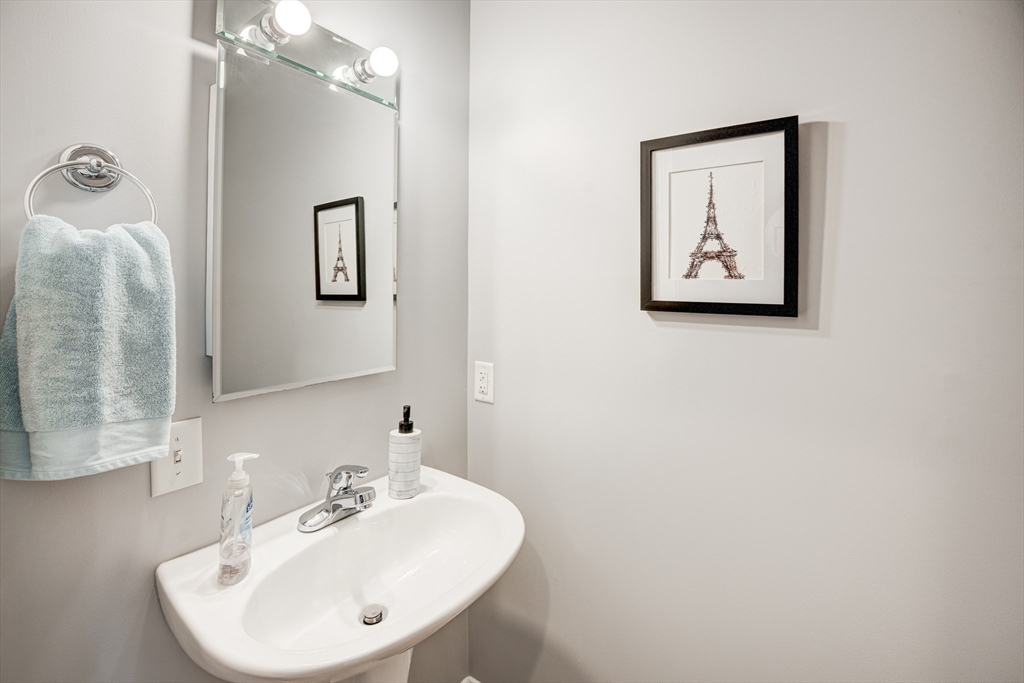 900 Lawrence Street, Unit 5 Lowell, MA 01852 - Photo 6 of 41 a bathroom with a sink and mirror