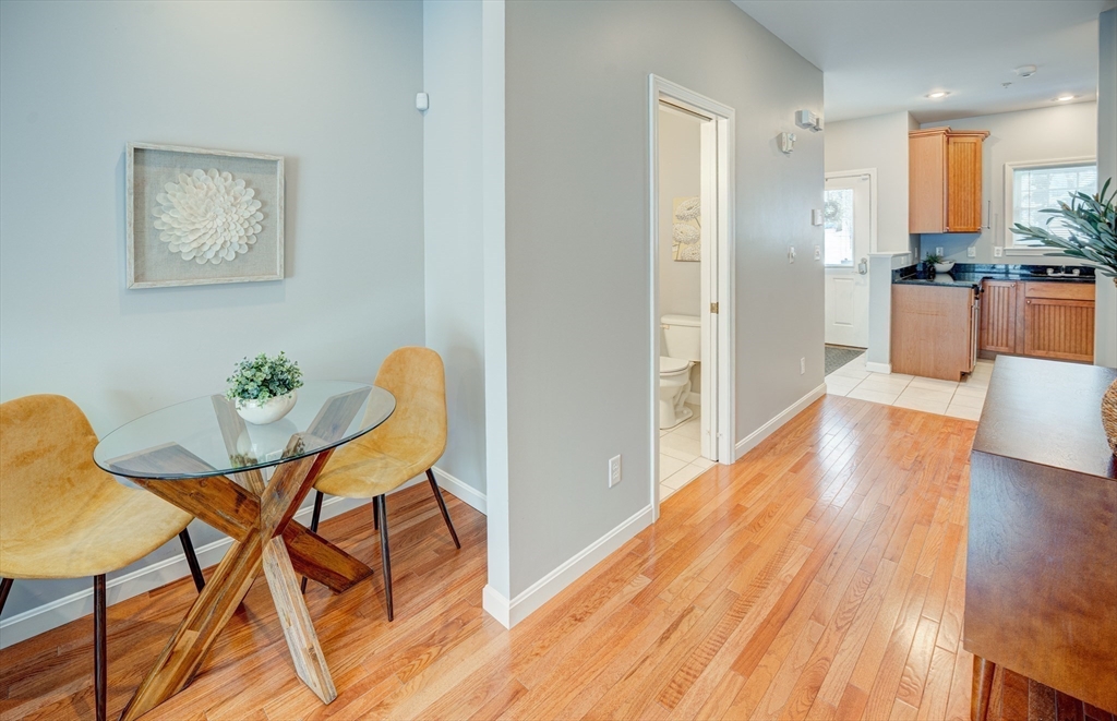 900 Lawrence Street, Unit 5 Lowell, MA 01852 - Photo 7 of 41 a view of a dining room with furniture and wooden floor