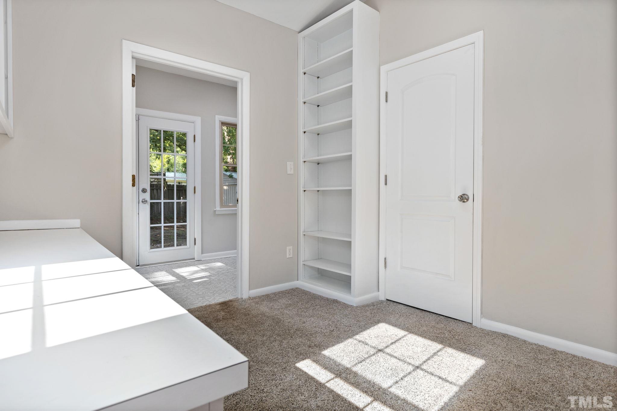 817 Chatham Lane Raleigh, NC 27610 - Photo 13 of 33 a view of an empty room with wooden floor and a window