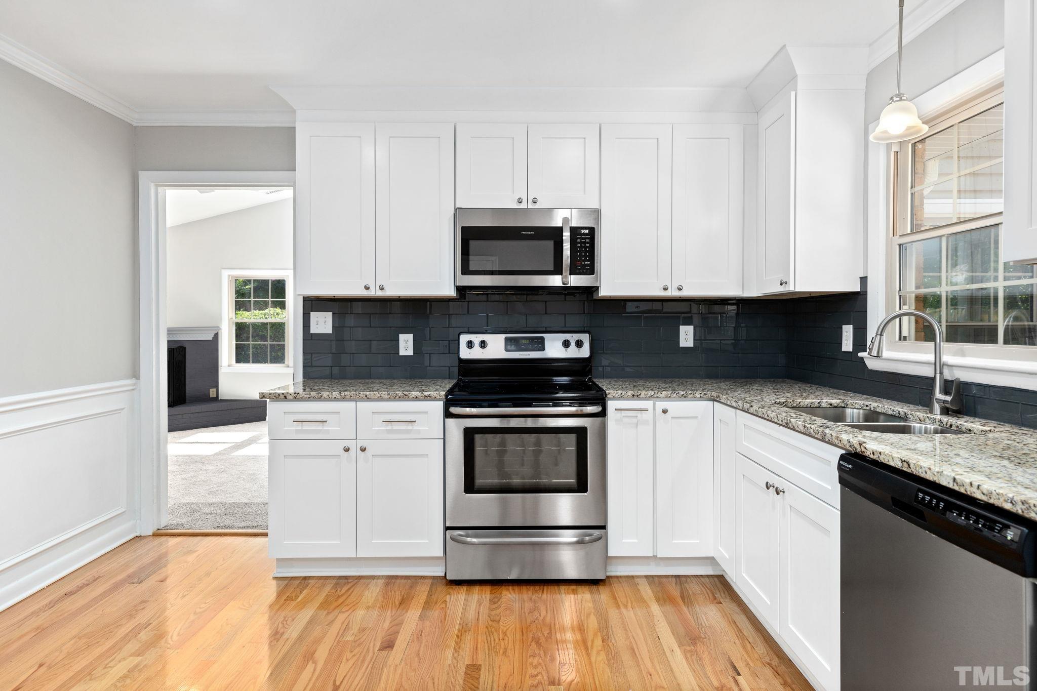 817 Chatham Lane Raleigh, NC 27610 - Photo 20 of 33 a kitchen with granite countertop a stove and a sink