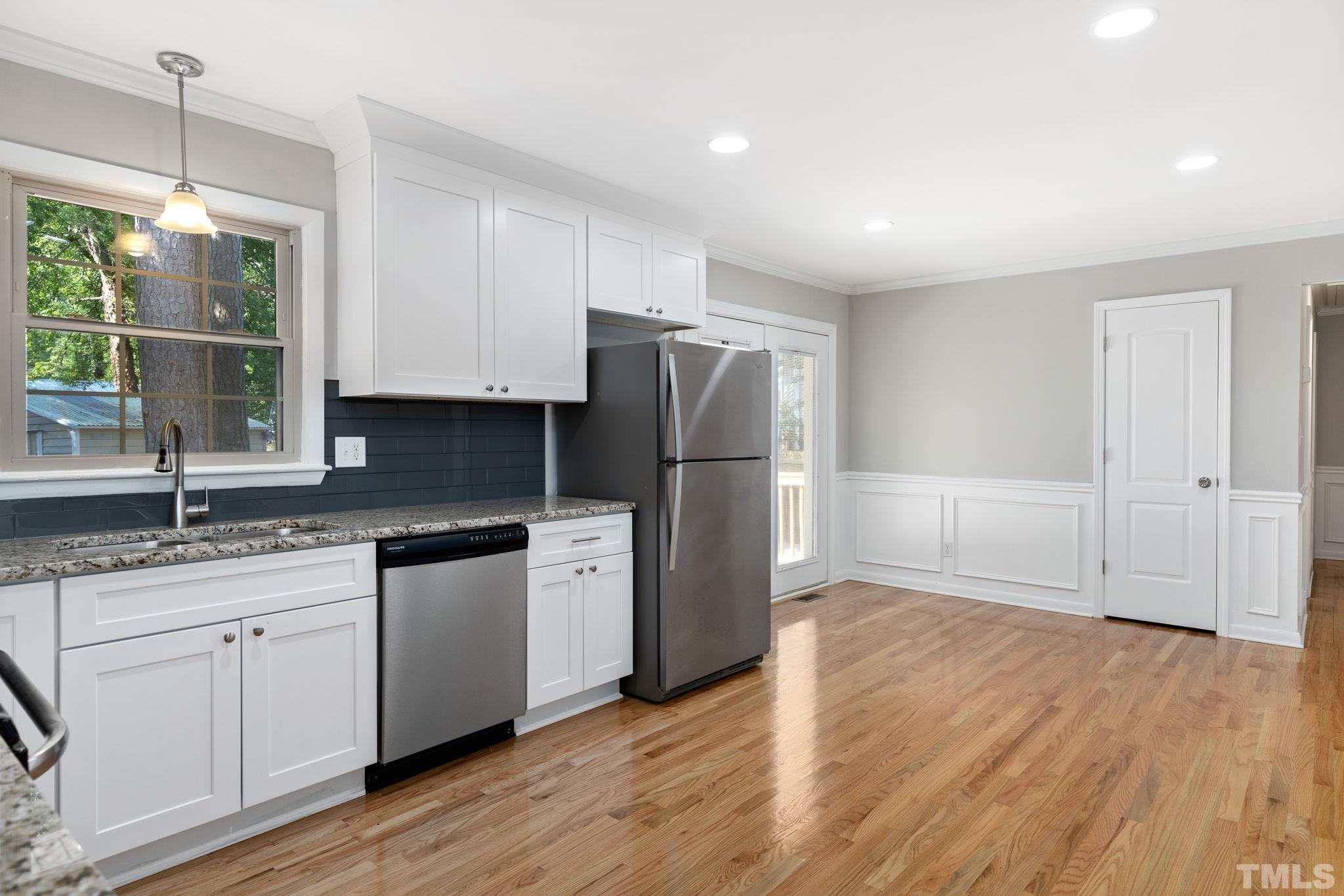 817 Chatham Lane Raleigh, NC 27610 - Photo 21 of 33 a kitchen with granite countertop a refrigerator sink and cabinets