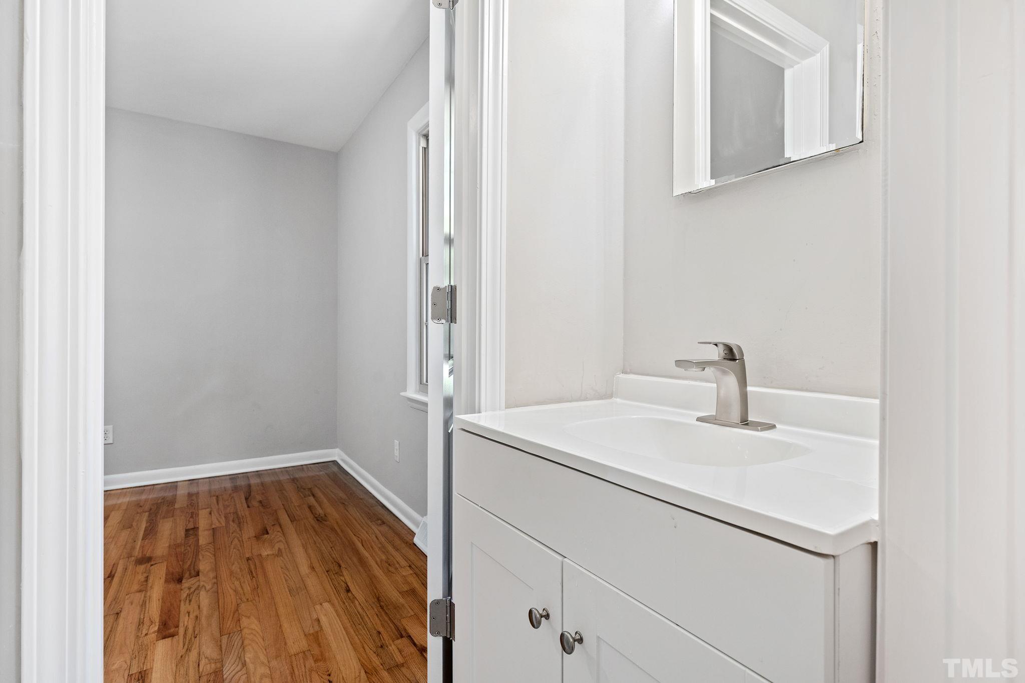 817 Chatham Lane Raleigh, NC 27610 - Photo 29 of 33 a bathroom with a sink and a mirror
