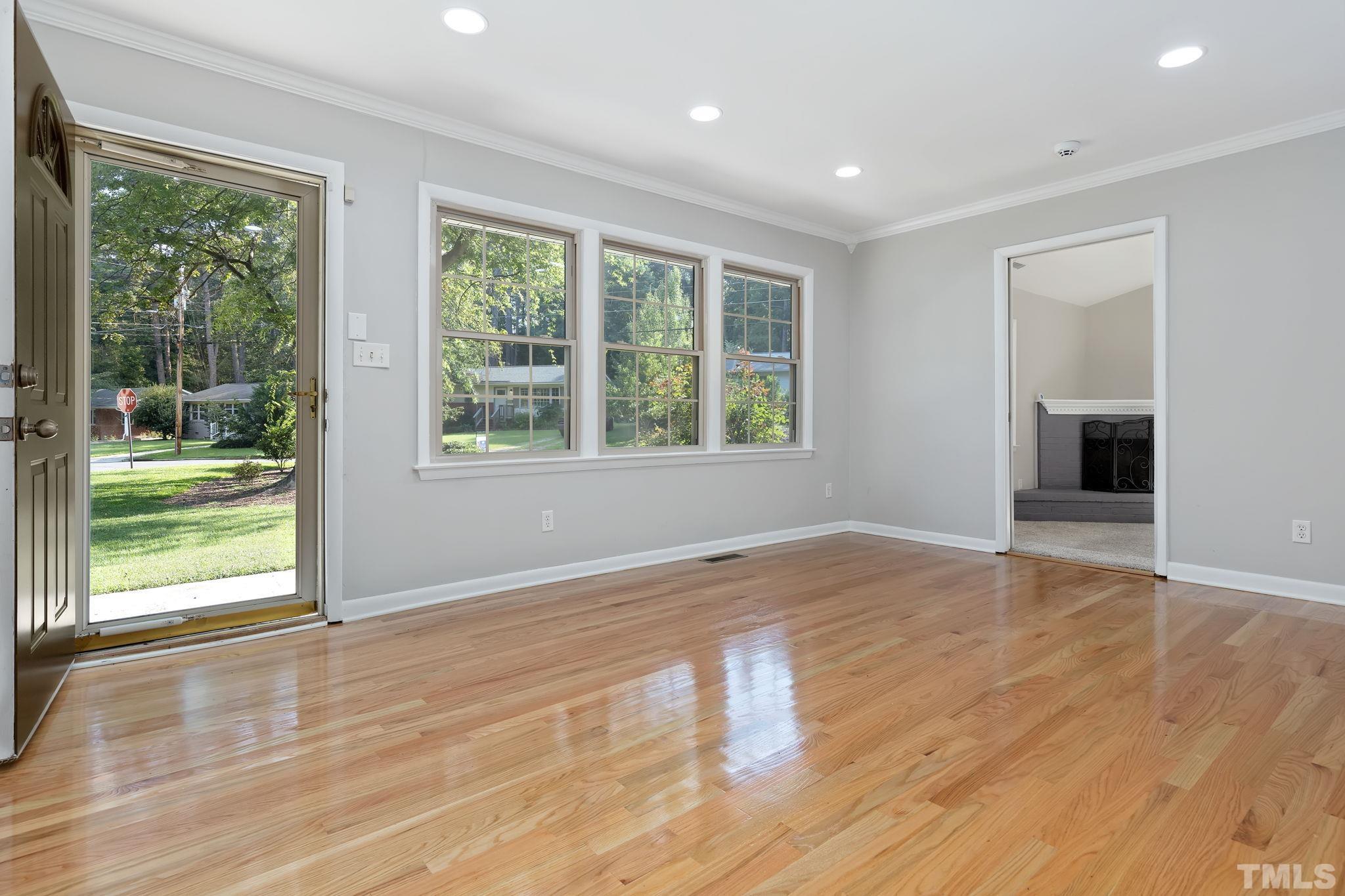 817 Chatham Lane Raleigh, NC 27610 - Photo 6 of 33 a view of an empty room with wooden floor and a window