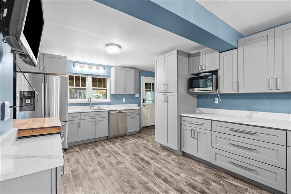 3855 Tuscarawas Road Beaver, PA 15009 - Photo 14 of 45 a kitchen with stainless steel appliances kitchen island granite countertop a refrigerator sink and microwave