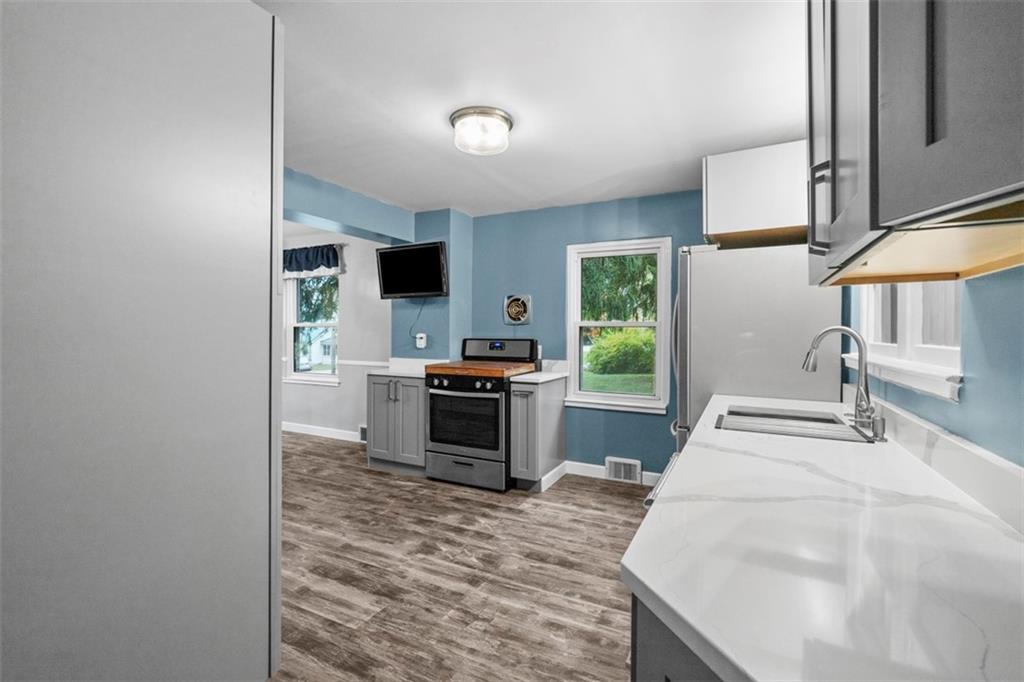 3855 Tuscarawas Road Beaver, PA 15009 - Photo 17 of 45 a kitchen with stainless steel appliances kitchen island granite countertop a sink stove and refrigerator