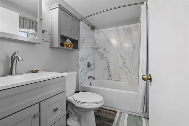 a bathroom with a sink toilet and shower