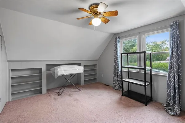 a bedroom with furniture and a ceiling fan