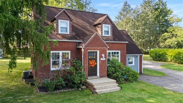 a front view of a house with garden