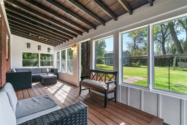 a living room with furniture and a floor to ceiling window