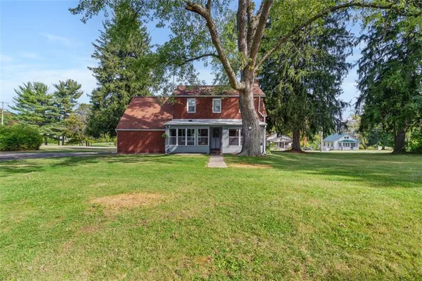 a front view of house with yard and green space